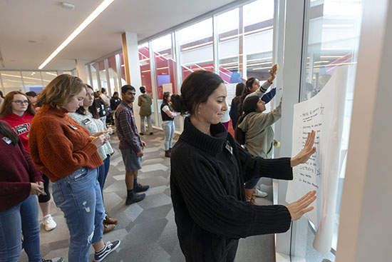 students writing on whiteboards in classroom